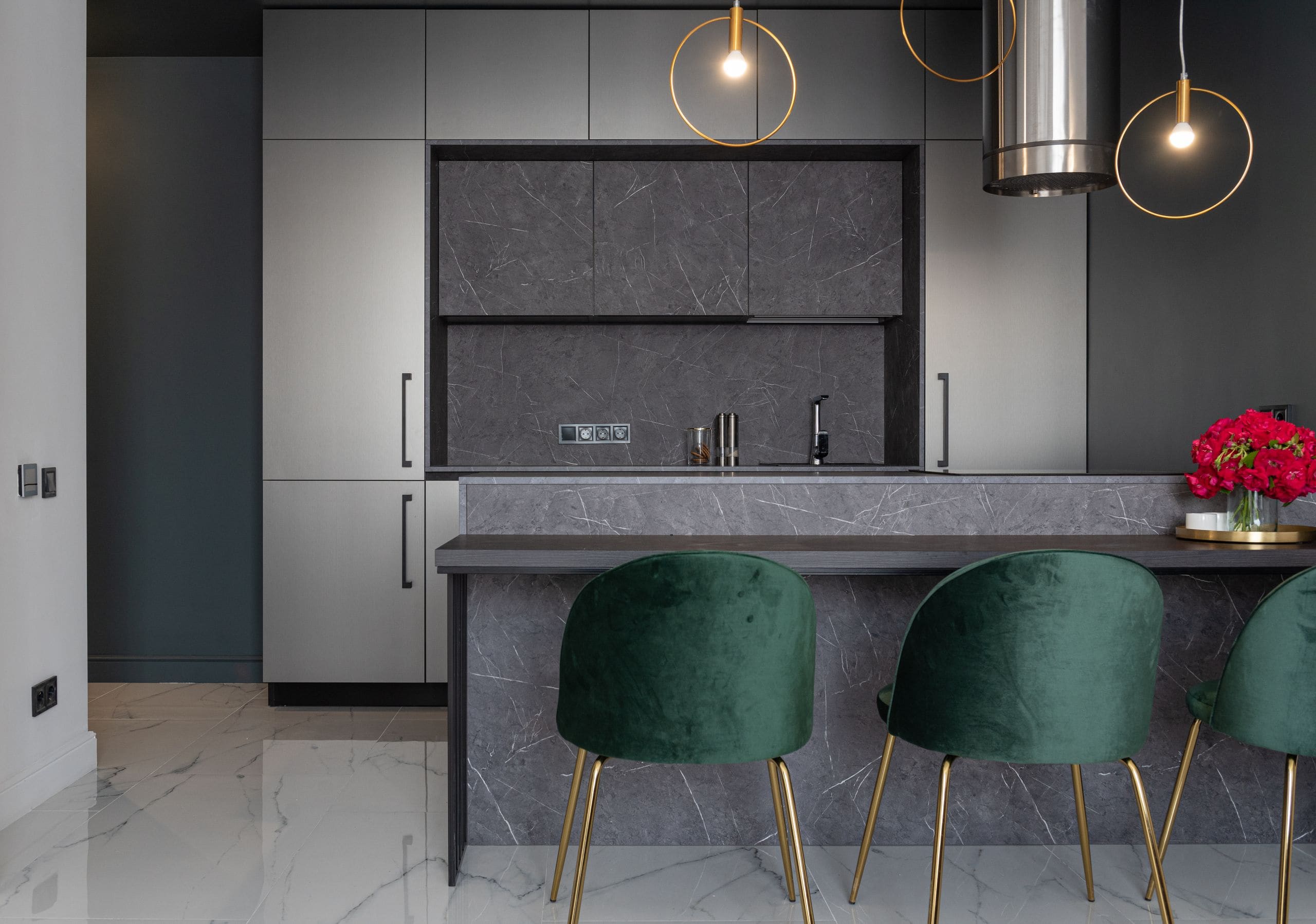 Designer kitchen with marble island, brass pendants and velvet seating, staged and photographed for campaign launch