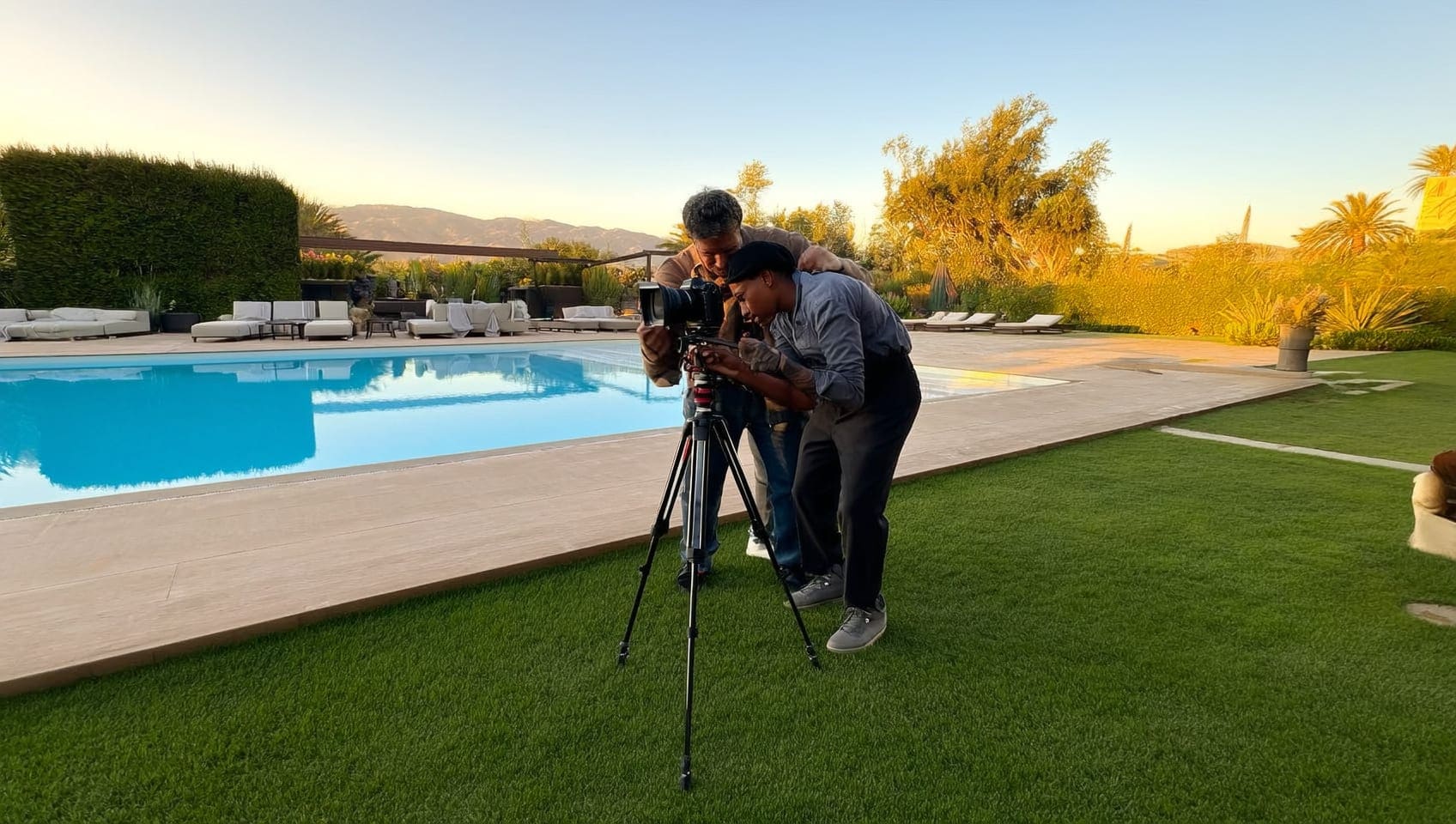 Editorial photographer capturing a luxury estate pool terrace at golden hour