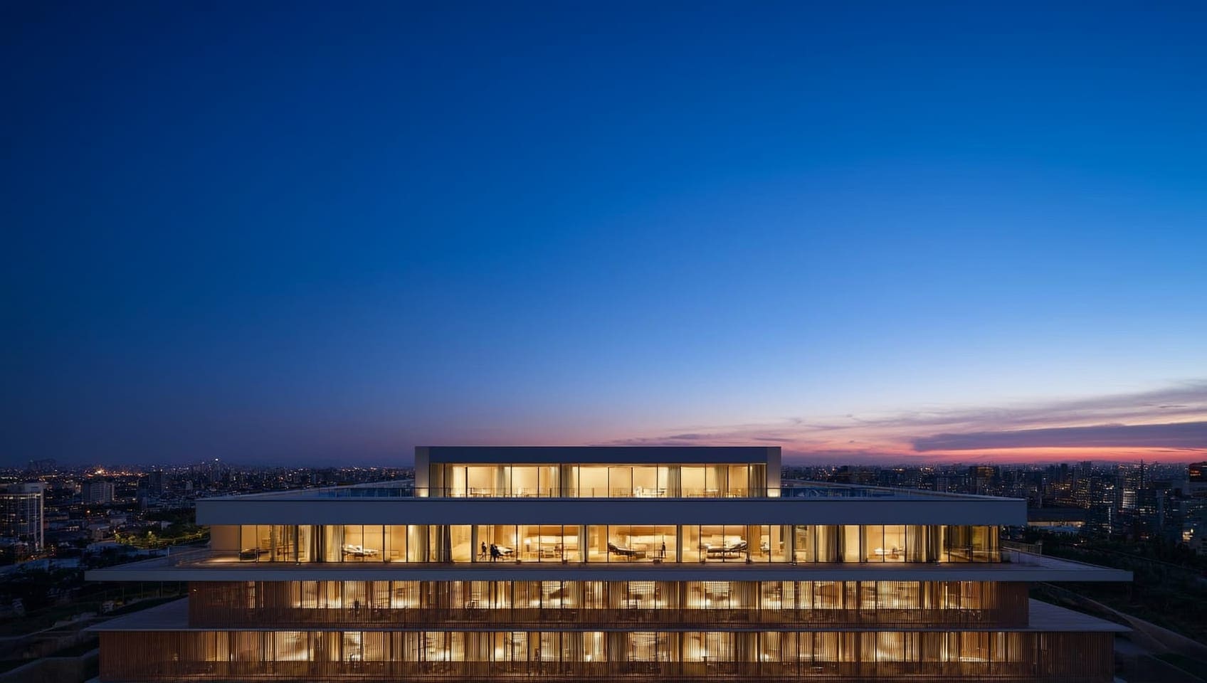 Modern estate glowing at twilight above the city